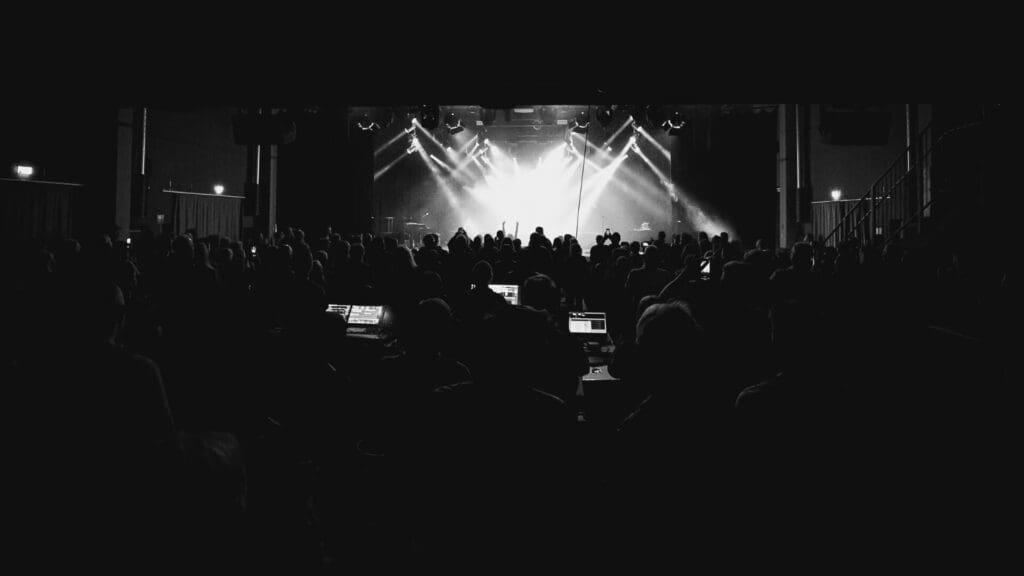 Konzert im westand Braunschweig: Blick über das Publikum auf die Bühne, die im Scheinwerferlicht leuchtet.